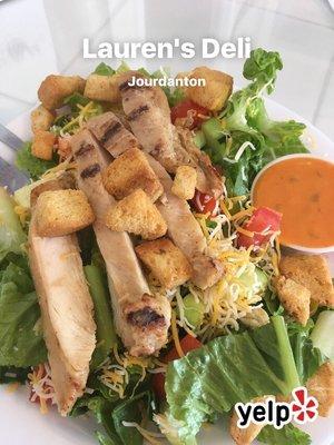 Grilled chicken salad- Mesquite grilled chicken breast strips, Colby jack cheese, lettuce, tomato, cucumber, croutons.