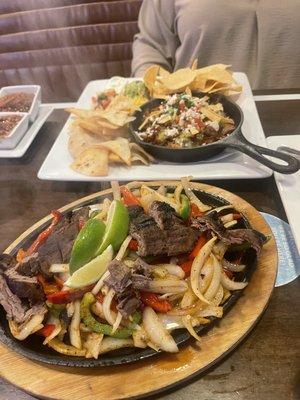 Steak fajitas on the bottom and carnitas skillet in the back. Be careful that's all the steak you get with fajitas majority vegetables