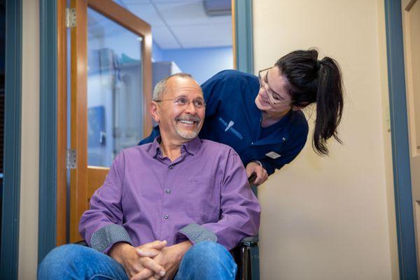 A patient smiling after his full arch rehabilitation procedure