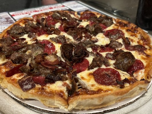 Small meat lover's pizza topped with pepperoni, bacon, sausage and meatball.