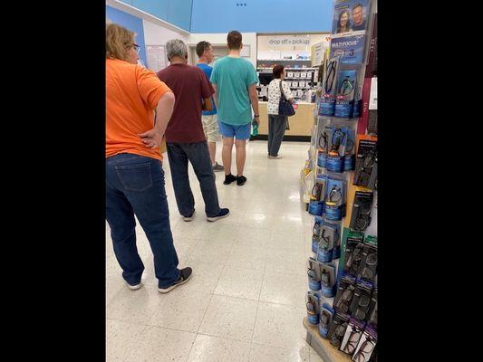 Long line at the pharmacy, wait time over twenty minutes.