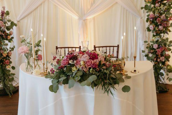 Sweetheart table with arch and florals