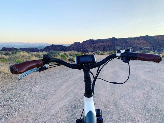 E-bike handlebars and an overlook of Snow Canyon