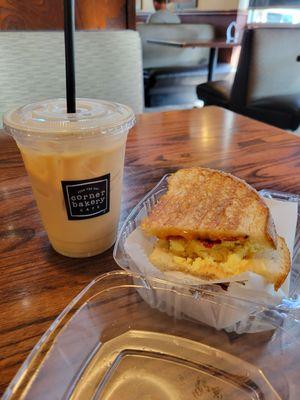 Medium iced vanilla almond milk latte and smoked bacon cheddar egg panini