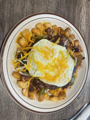 Breakfast dish with home fries, grilled corned beef hash and eggs.  I believe it was called The Wordmen or similar.