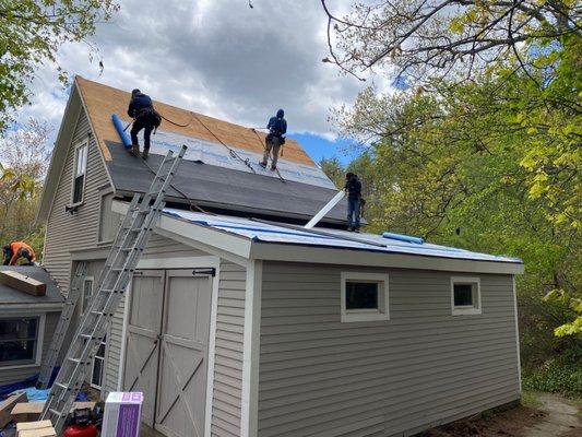 Asphalt roof installation in process.