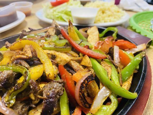 Mixed fajitas with steak and chicken served with 4 heated tortillas