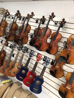 A vast assortment of violins, violas, ukuleles