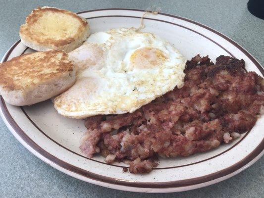 Corned beef hash, three eggs, and a biscuit