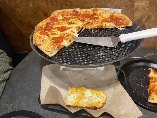 Large pepperoni pizza and garlic cheese bread. We couldn't help ourselves I took a picture before it was all gone