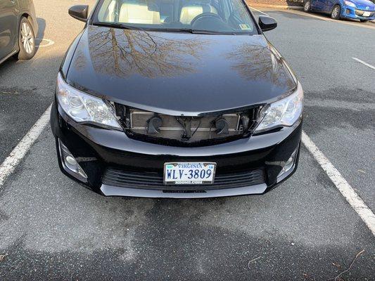 My car after paying $930. This is how they returned my car to me. They put my old grill in the trunk and we had to reattach it ourselves.