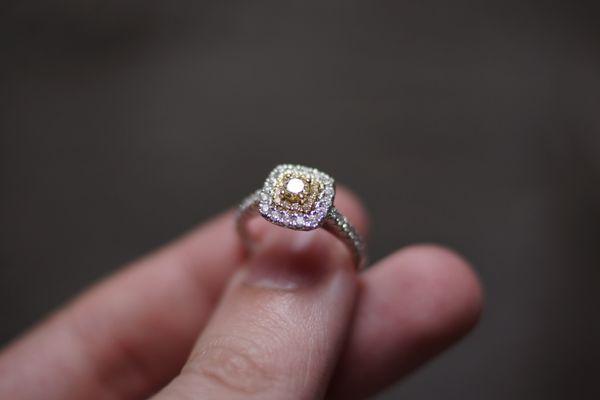 Canary Yellow Diamond surrounded by a Halo of more yellow diamonds. Finished off with a halo of diamonds that travels down the band.