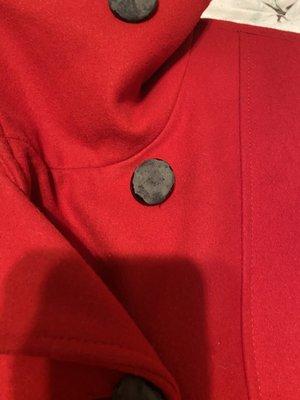 Coat with covered buttons melted