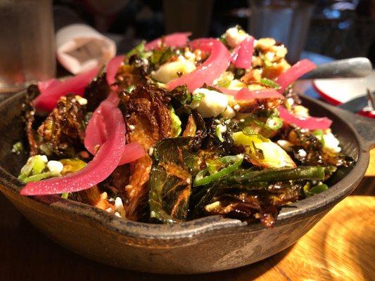 Brussels with goat cheese and pickled onions in a skillet