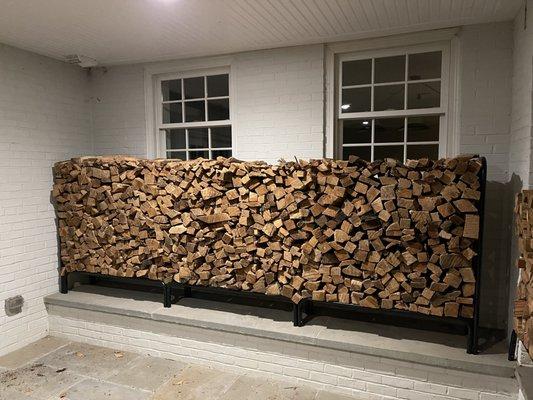 Oak kiln-dried firewood stacked on a rack in McLean, VA