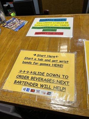 Signs at the bar where you pay