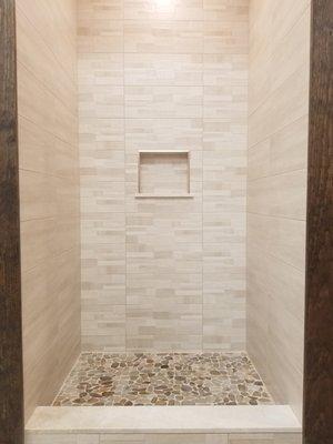 Beige Stacked Decorative Tile , Plain Beige stacked on side walls with Natural Pebbles on shower floor