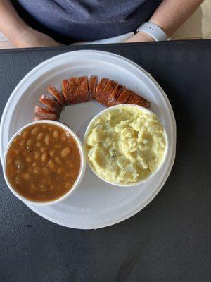 Sausage plate with bbq beans and potato salad.