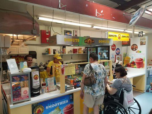 Mini donuts in Renningers flea market. Mike helping customers.