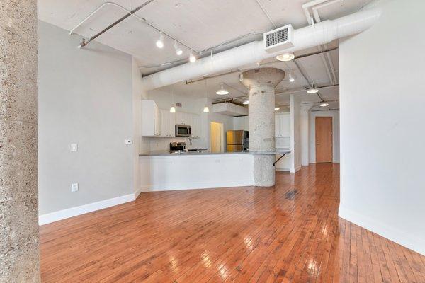 Spacious living room with concrete pillars and hard wood flooring at South Side on Lamar