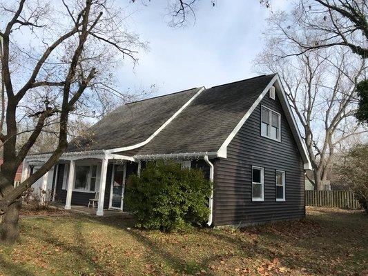 CertainTeed Monogram "Slate" vinyl siding and bright white trim look fabulous on this classic Cape Cod.