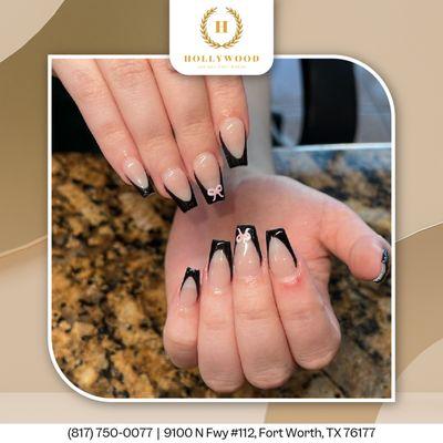 Elevate your style with black French tips and delicate ribbon art for a chic, refined look.