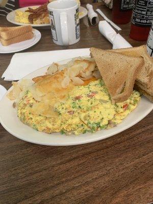 A very loaded Vegetable omelet.  Comes with potatoes, and toast.  Great deal of food , very modest price!