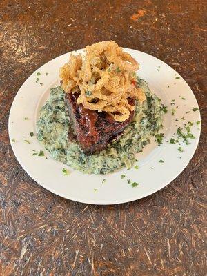 Smoked Meatloaf on a bed of Creamed Spinach with Tobacco Onions on top