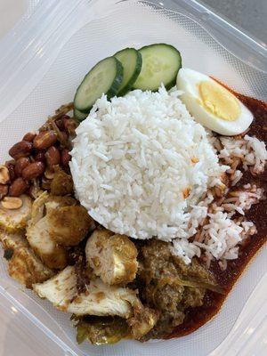 Nasi lemak. Fragrant coconut rice with spiced fried chicken, beef rendang, peanuts and ikan billis.