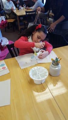 My daughter painting her motorcycle