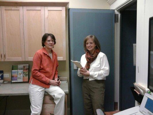 Standing outside our sound proof booth, Dr. Olenick consults with Caroline Kerr.