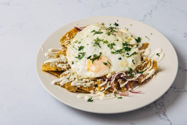 Chilaquiles - tortilla chips, tomatillo salsa, eggs, queso fresco, lime crema, onions and cilantro
 [vegetarian]