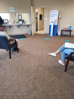 Waiting area with self check-in machine.