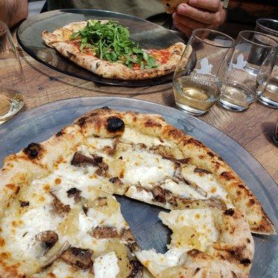 Fun Guy pizza in the front and Hot Honey in the back under all that arugula.