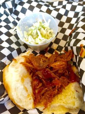 Pulled pork sliders with cole slaw on a Hawaiian roll.