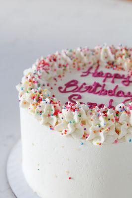 Gluten-free cake with whipped topping, profile view