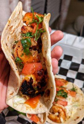 Close-up of a fully dressed Blackened Shrimp Taco with Mango Hab sauce and fresh lime squeeze. Absolutely amazing.