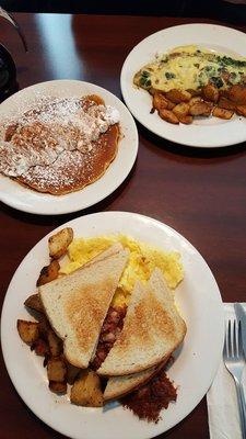 Pumpkin pancake, omelette, and the 2 eggs plate with hash.