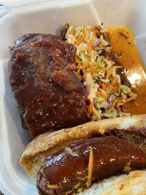 Sampler plate- ribs, pulled pork, smoked link on a bun with coleslaw.