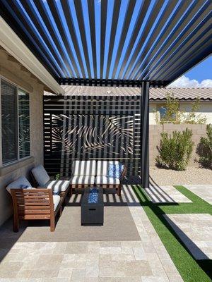 Beautiful Pergola with privacy wall, travertine and artificial grass with stepping stones