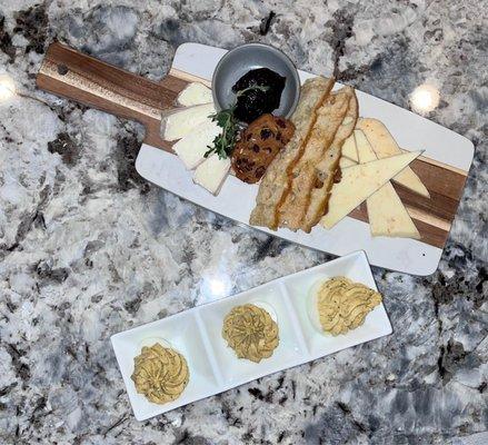 Cheese Board with vampire slayer cheddar and truffle tremor goat cheese. Chipotle spiced deviled eggs.