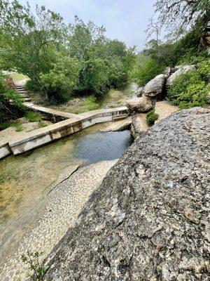 Rocks above the well.. in the rain but still beautiful, you can see how low the water level is