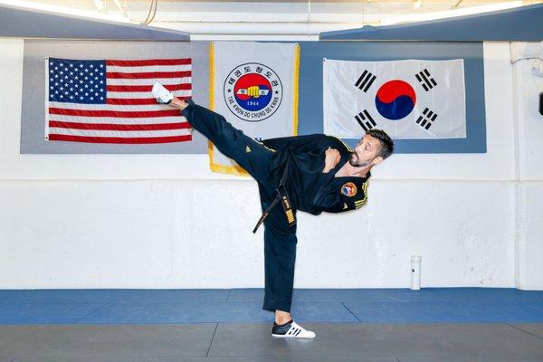 Master Paul Rose, owner of the Michigan Academy of Taekwondo, displays a side kick.