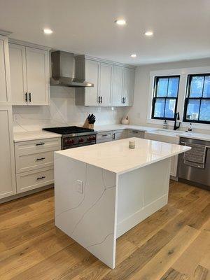 Waterfall Island & counters along with full height backsplash, all done w Quartz. Just beautiful