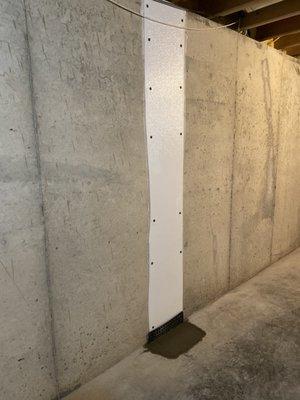 Sealed wall crack, with freshly poured concrete.