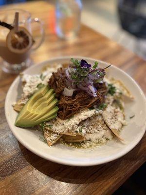 Chilaquiles en salsa verde con birria (super good) Cafe de la olla in the background (to die for)