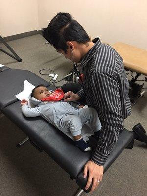 Here's dr Wu, Chiropractic Physician performing a check up on a one year old after he was involved in an auto accident.