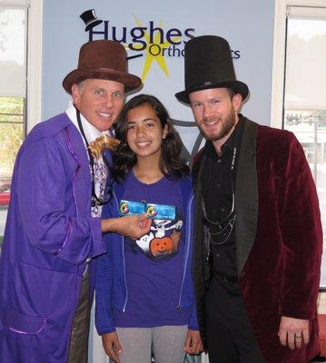 Drs. Herb and Justin (dressed up for halloween) presenting movie tickets to our recent T-Shirt contest winner!!