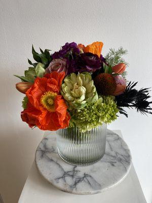 Poppies, veggie roses, ranunculus and thistle create a unique and delightfully unexpected floral arrangement.