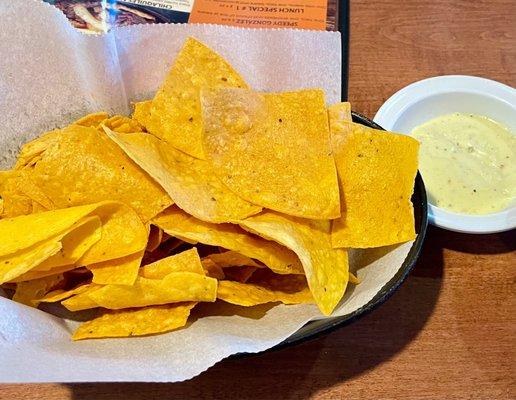 Chips, salsa, and some kind of white sauce.